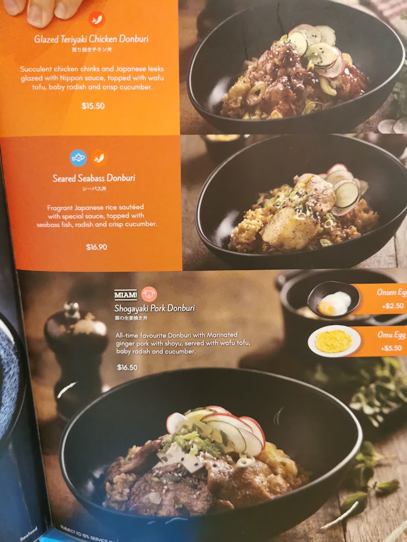 A close-up of Miam Miam's menu featuring various Japanese-French fusion Donburi dishes and egg add-ons.