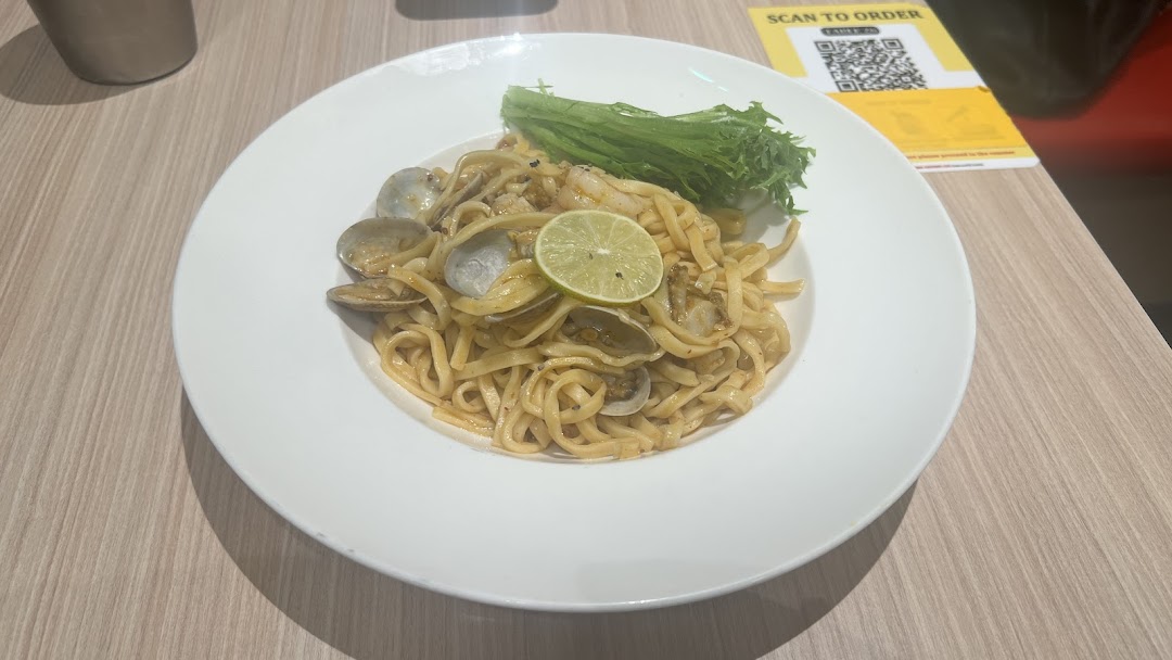 A delicious plate of pasta with clams, shrimp, fresh lime, and crisp lettuce at Milan Shokudo.