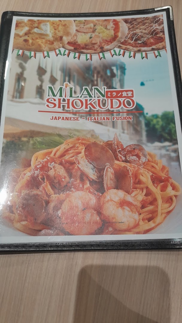 The cover of Milan Shokudo's menu, featuring their Japanese-Italian fusion cuisine and a seafood pasta dish.