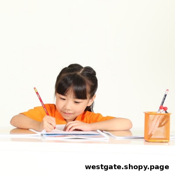 A young girl in an orange shirt diligently writing at a desk with a pencil.