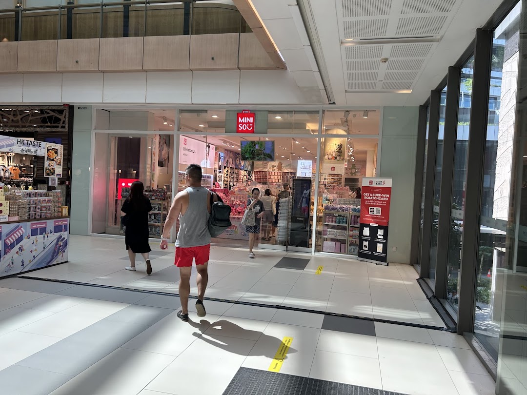 The MINISO Westgate shop entrance with shoppers entering and browsing its diverse product range.