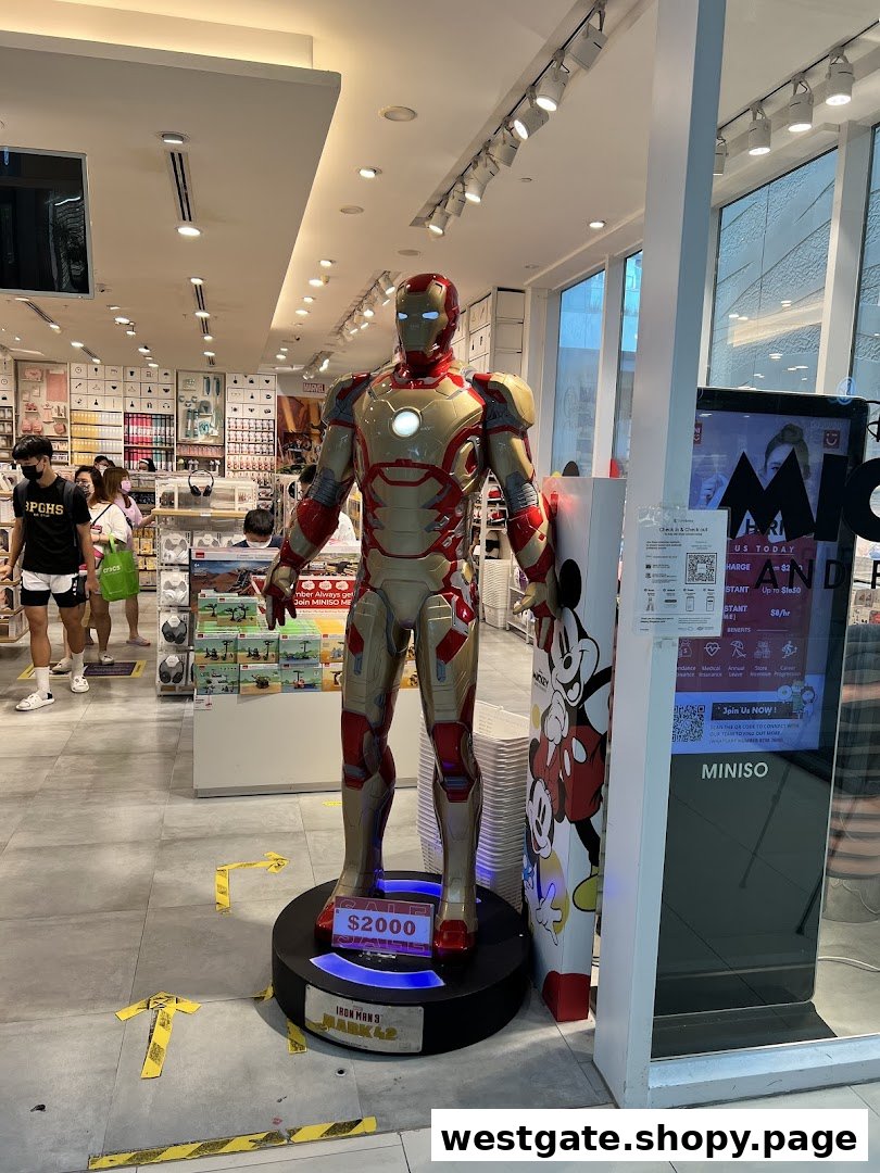 An Iron Man statue stands prominently inside a MINISO store, with shoppers browsing products.