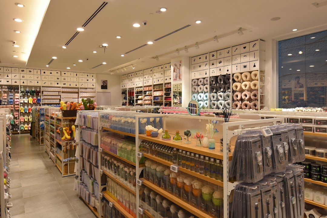 An interior view of MINISO, showcasing aisles filled with diverse lifestyle products, home goods, and accessories.