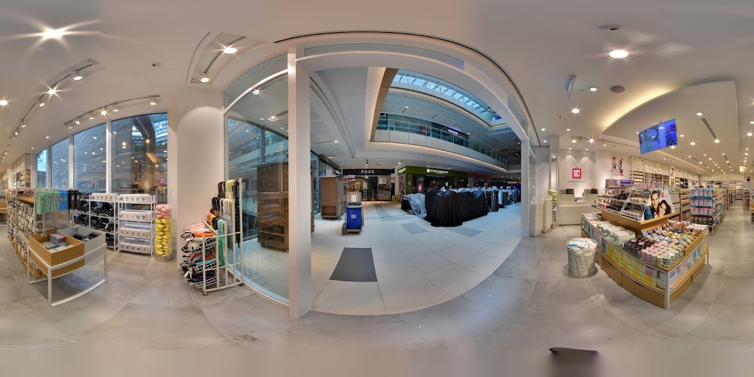 A panoramic view of the MINISO store interior, showcasing diverse products and the mall corridor outside.