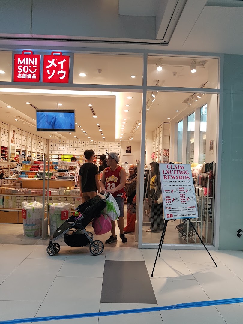 The bright entrance of MINISO Westgate, showcasing its diverse range of affordable lifestyle products and a promotional sign.