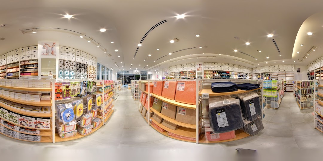A wide-angle interior view of MINISO Westgate, showcasing brightly lit aisles filled with diverse lifestyle products and organized displays.
