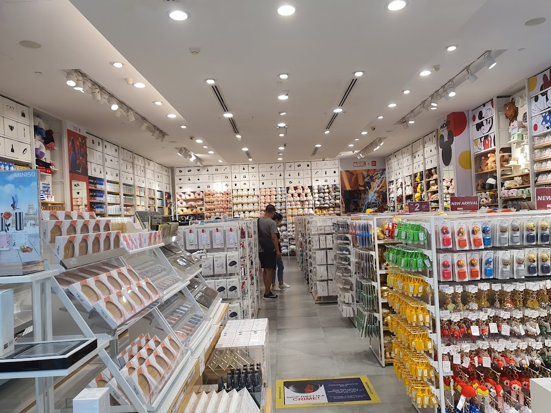 An interior view of MINISO Westgate, showcasing a wide array of lifestyle products, plush toys, and accessories on well-lit shelves.