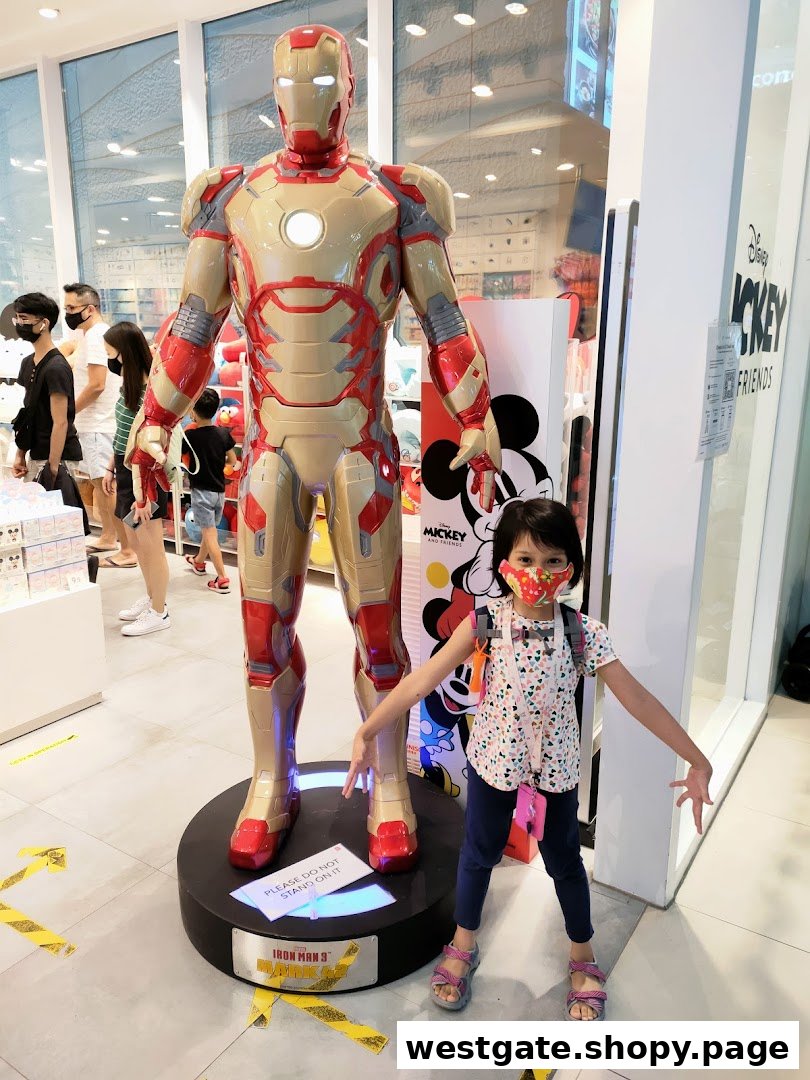 A child poses with a life-sized Iron Man statue inside MINISO, featuring Disney Mickey & Friends branding.