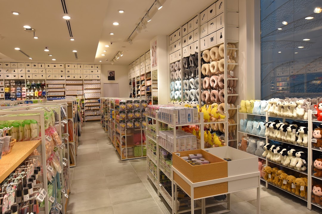 An interior view of MINISO, showcasing aisles filled with diverse lifestyle products, plush toys, and accessories.