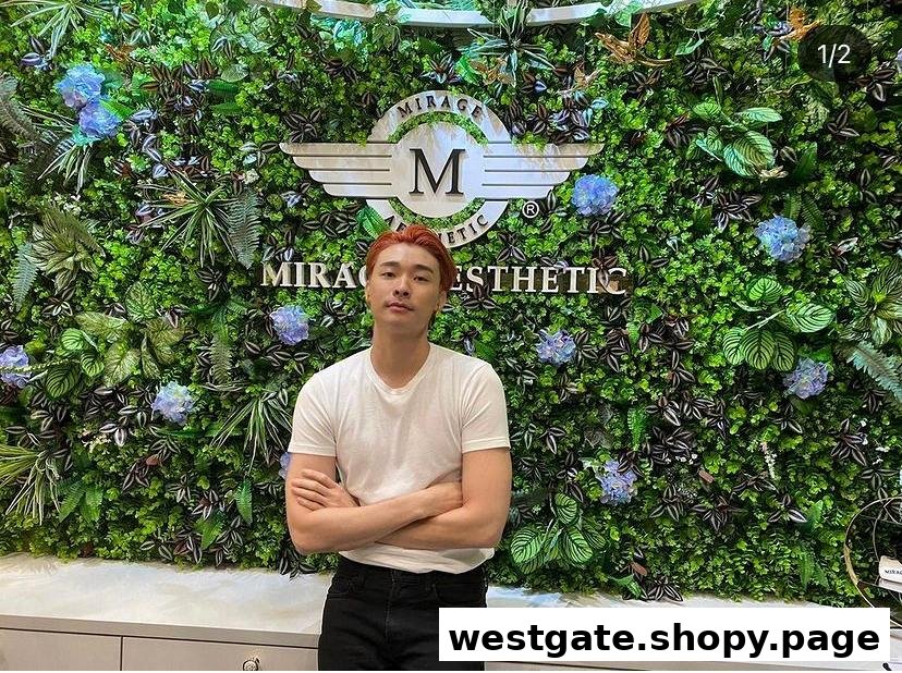 A man stands in front of a lush green wall featuring the Mirage Aesthetic logo.