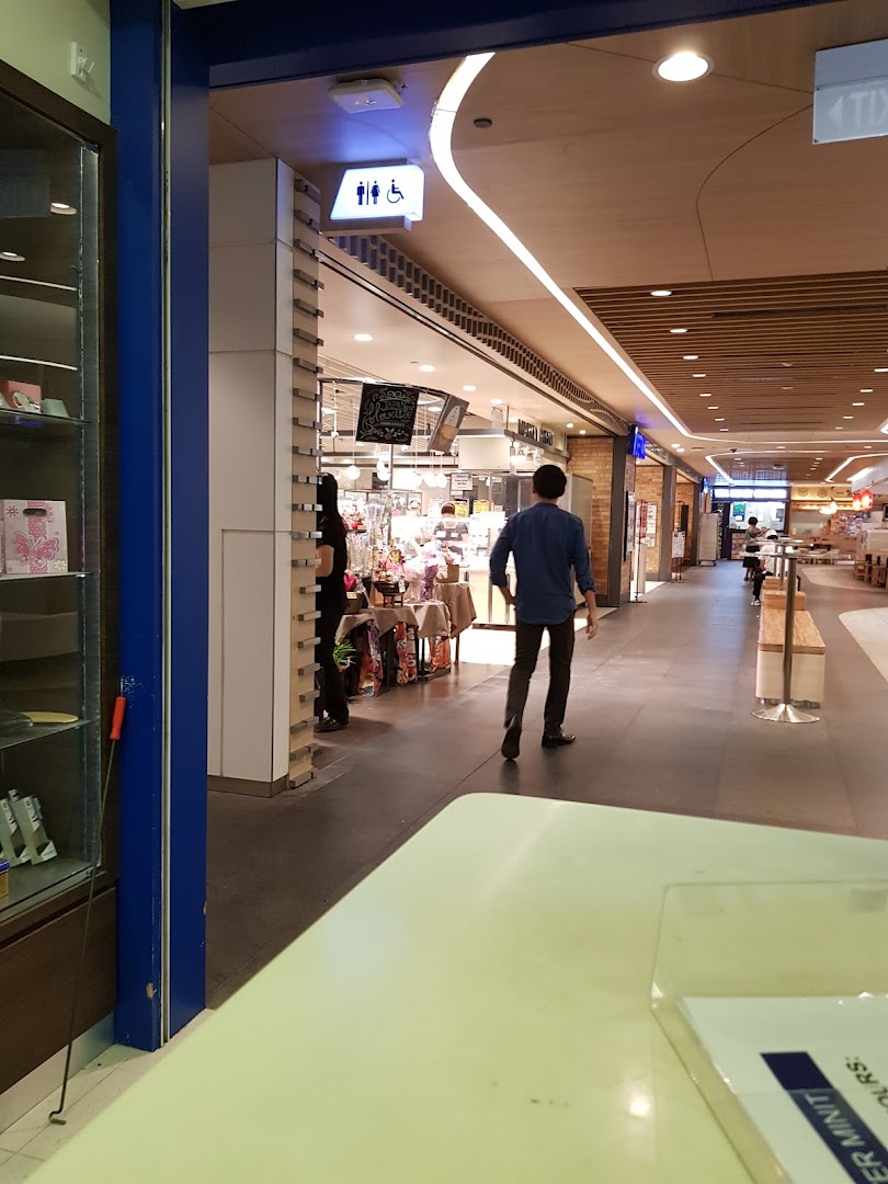 View into Mister Minit Westgate from the mall corridor, showing its entrance and surrounding area.