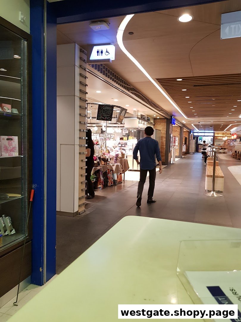 View into Mister Minit Westgate from the mall corridor, showing its entrance and surrounding area.