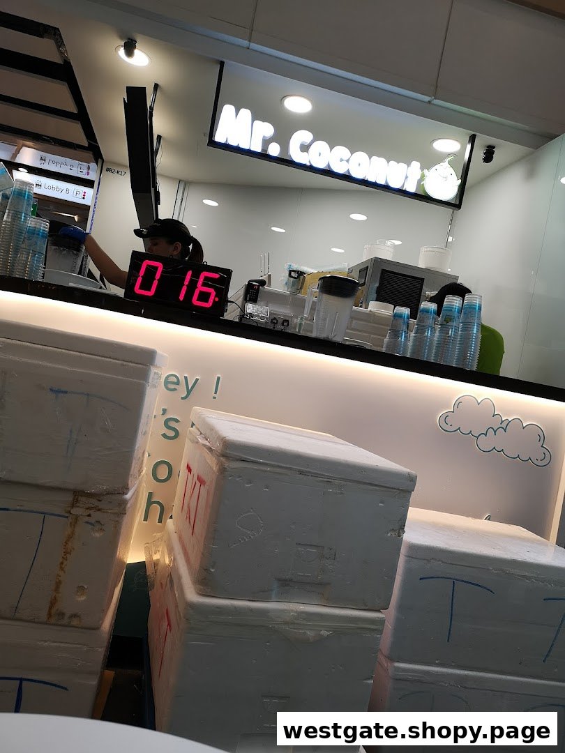 Interior view of Mr. Coconut shop with staff preparing drinks and visible equipment.