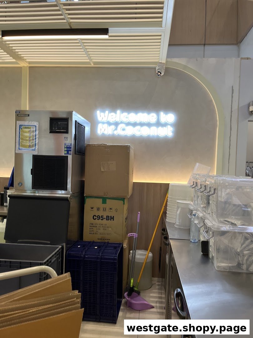 Interior view of Mr. Coconut showing equipment, storage, and a neon 'Welcome' sign.