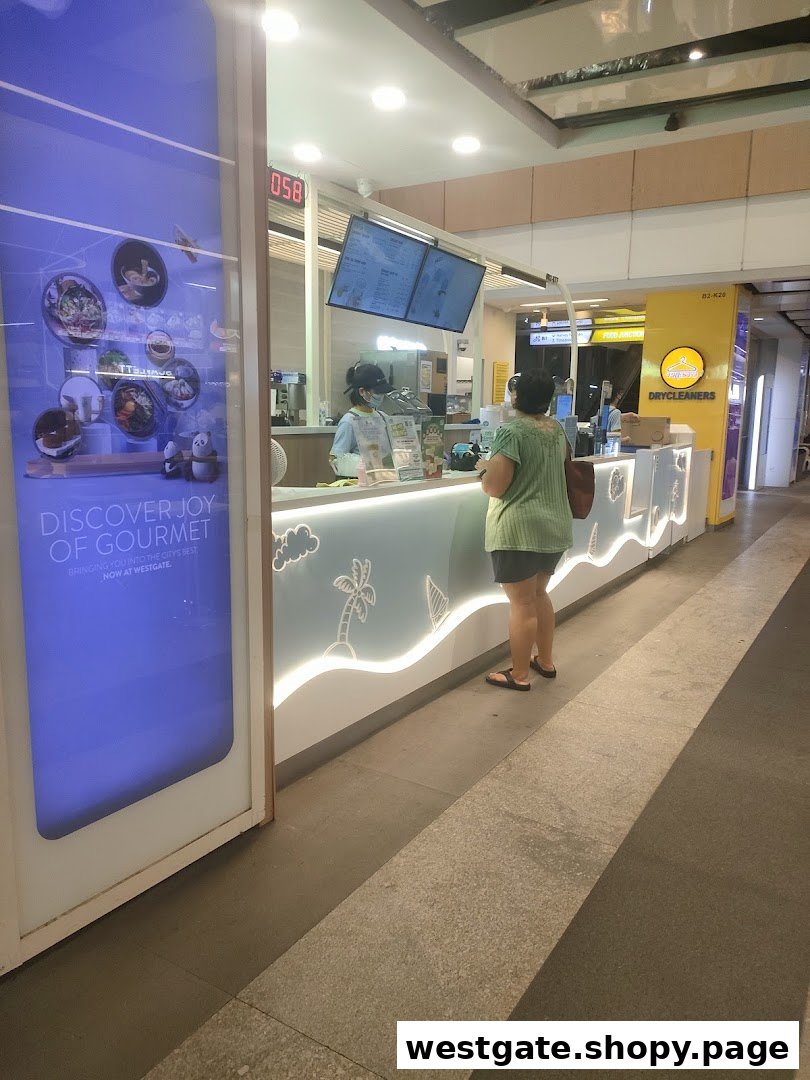 A customer orders at the counter of Mr. Coconut, a beverage shop, with digital menu screens visible.