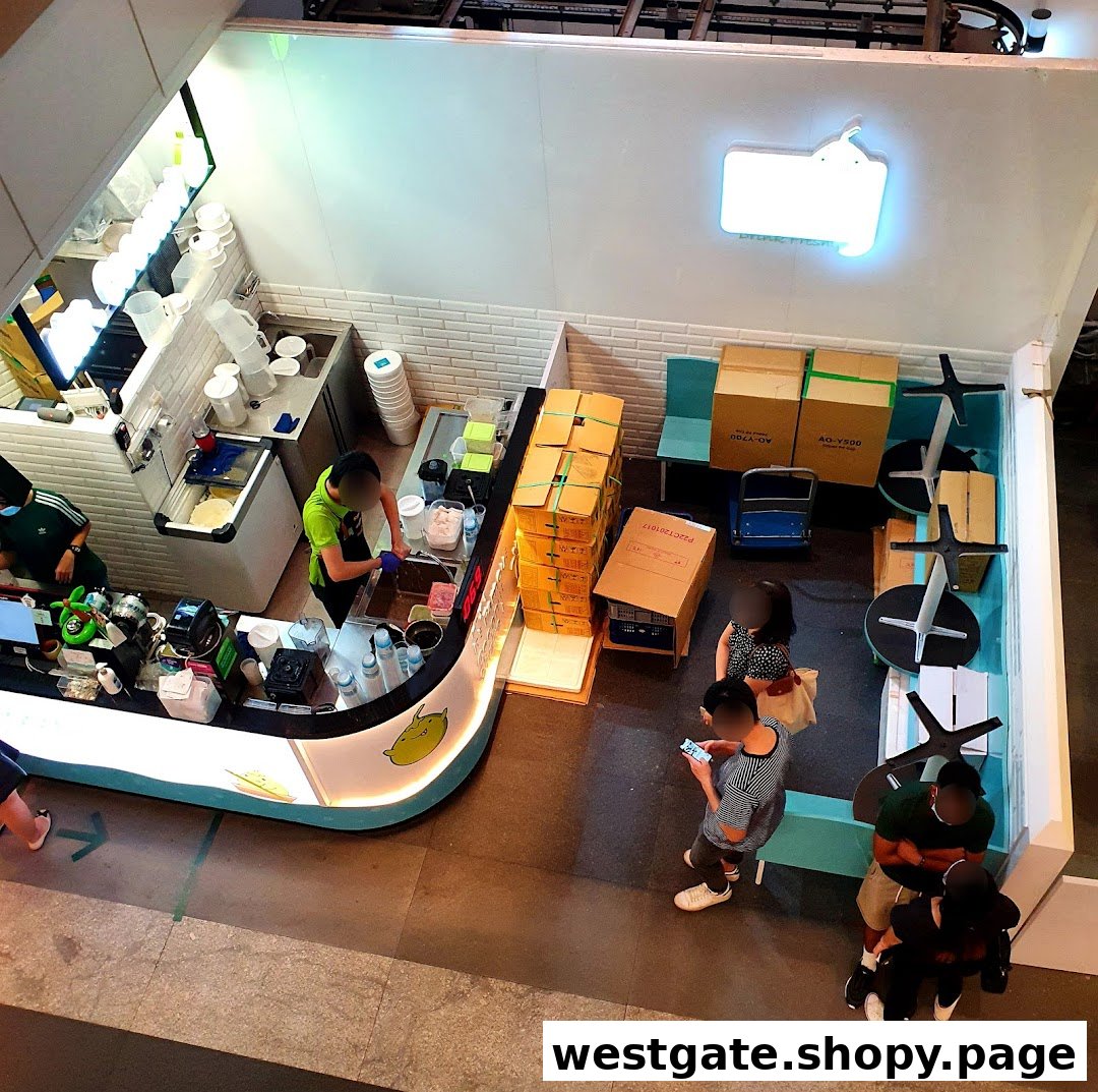 Overhead view of Mr. Coconut shop interior with staff preparing orders and customers waiting.