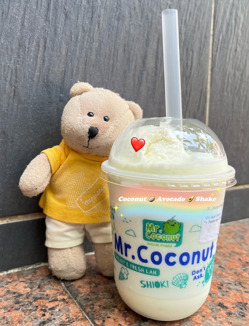 A Mr. Coconut drink, specifically a Coconut Avocado Shake, with a teddy bear.
