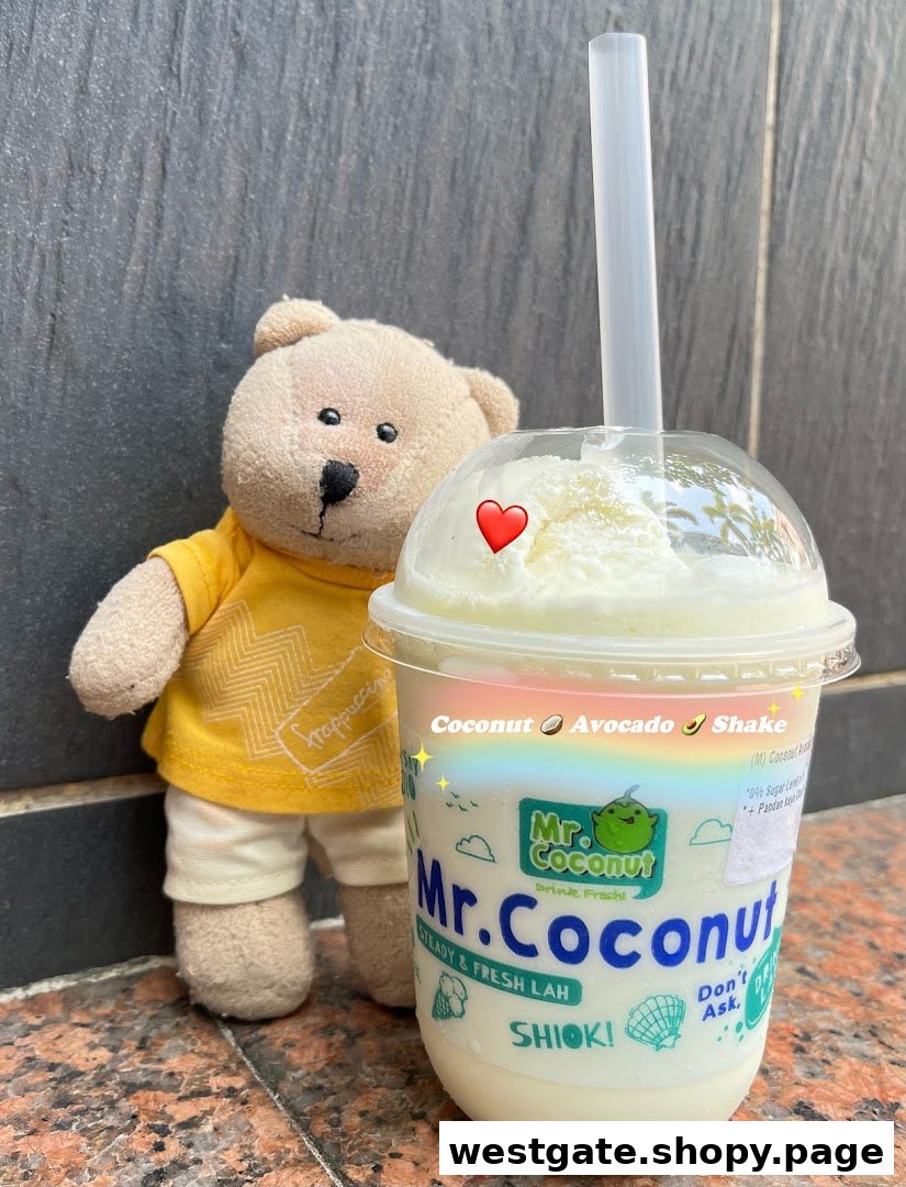 A Mr. Coconut drink, specifically a Coconut Avocado Shake, with a teddy bear.