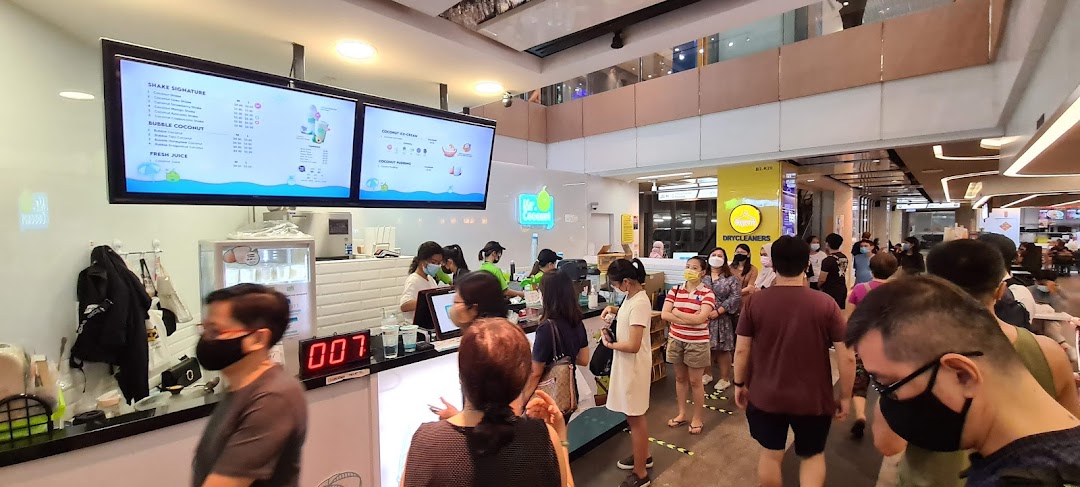 A bustling Mr. Coconut shop with customers queuing for refreshing coconut-based drinks and desserts.