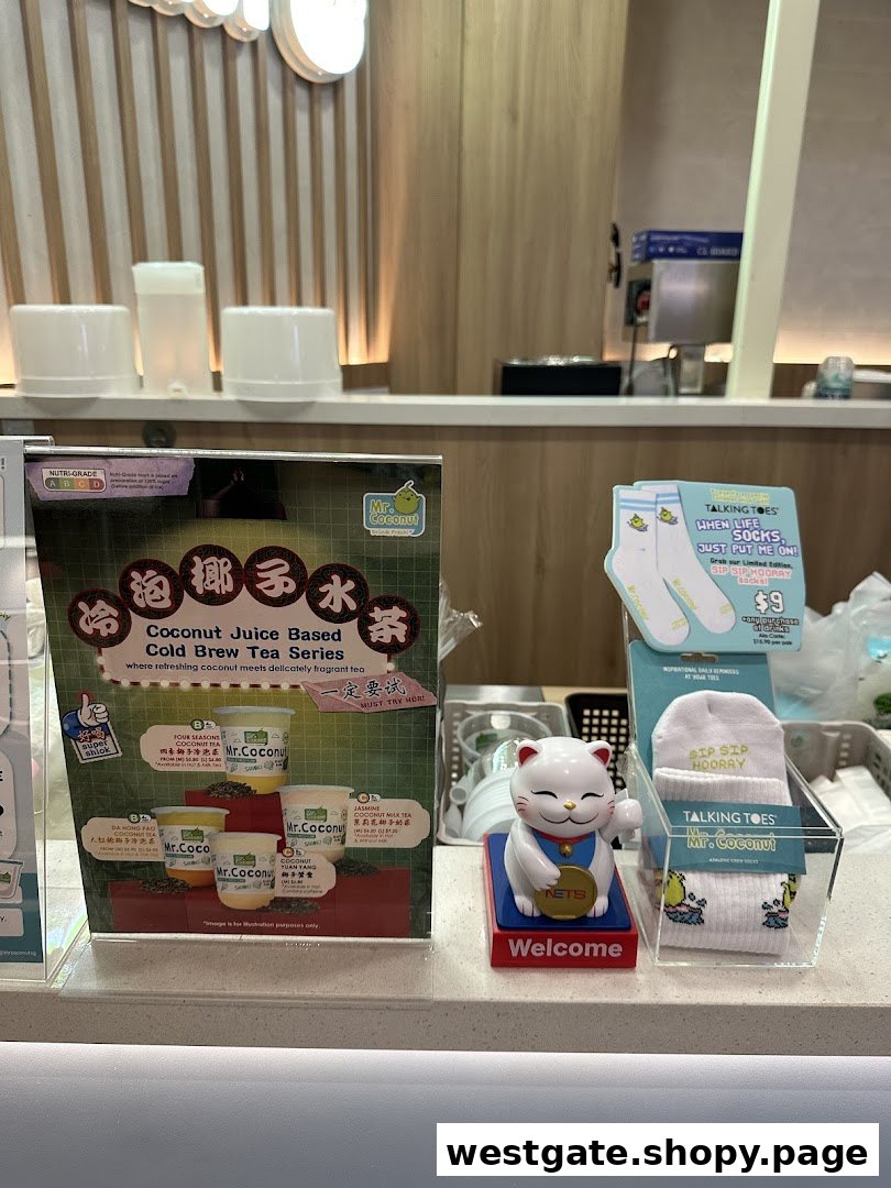 A Mr. Coconut counter featuring a cold brew tea series display, a Maneki-neko cat, and branded 'Talking Toes' socks.