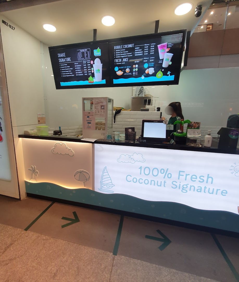 Interior view of Mr. Coconut shop featuring prominent digital menu boards and a service counter.