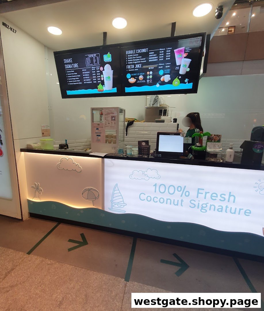 Interior view of Mr. Coconut shop featuring prominent digital menu boards and a service counter.