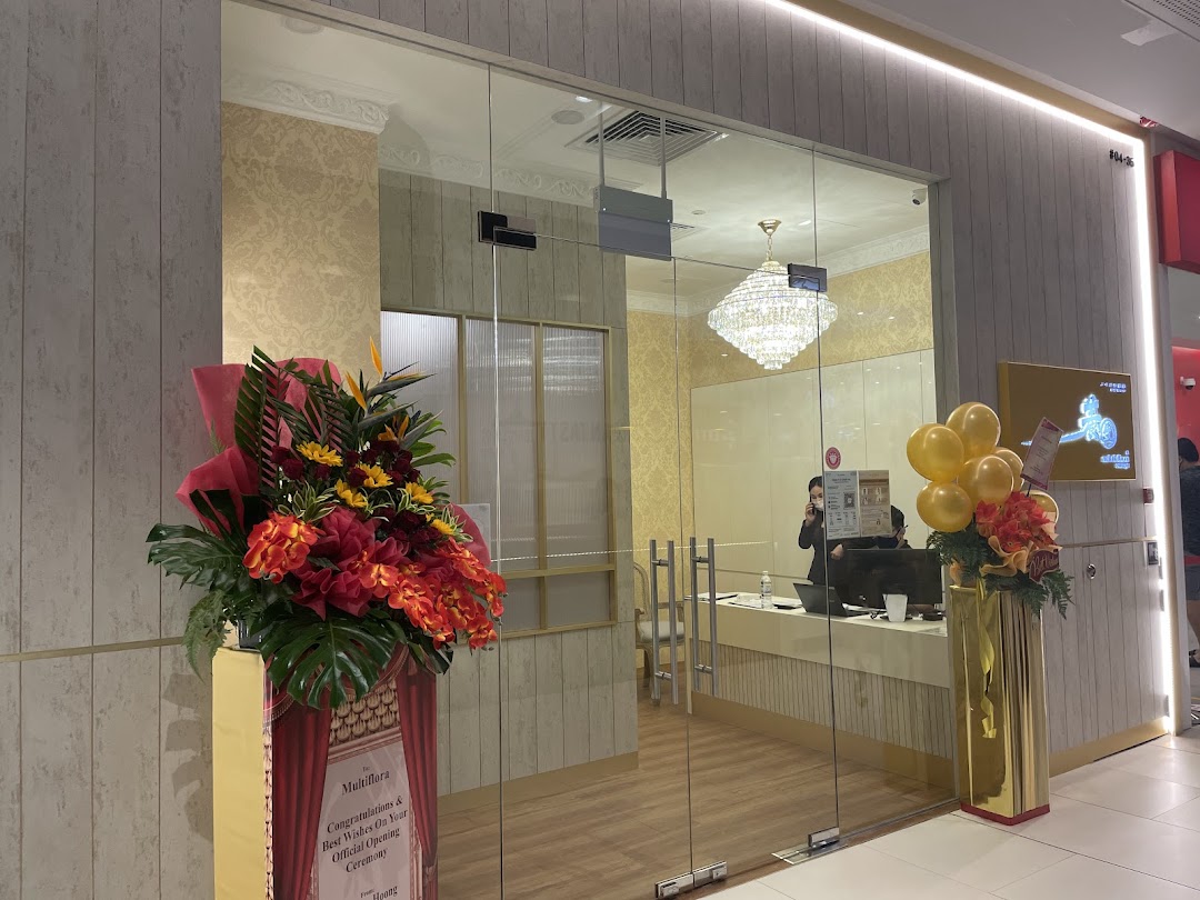 The elegant glass entrance of Multiflora TCM Spa, decorated with festive floral arrangements and balloons.