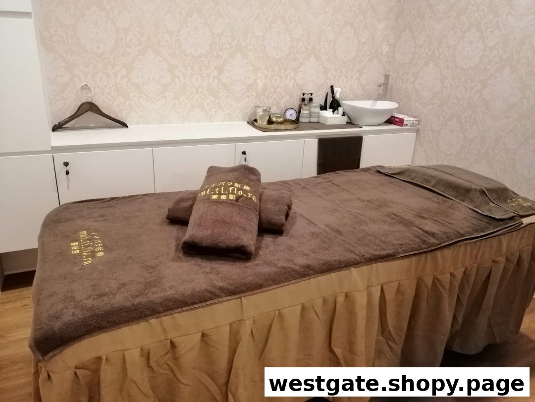 A serene spa treatment room featuring a massage bed, towels, and a wash basin.