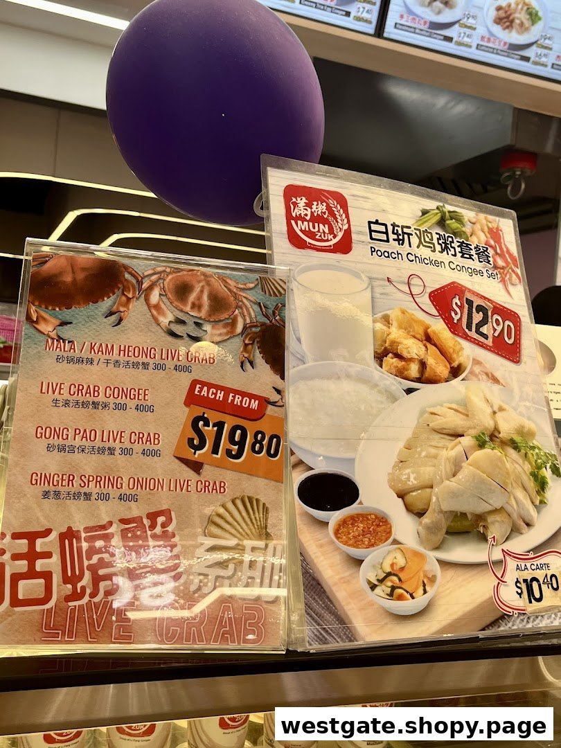 Close-up of promotional displays featuring live crab dishes and a poached chicken congee set.