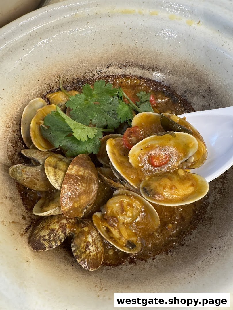 Close-up of savory clams cooked in a rich sauce, garnished with fresh cilantro, served in a rustic bowl.
