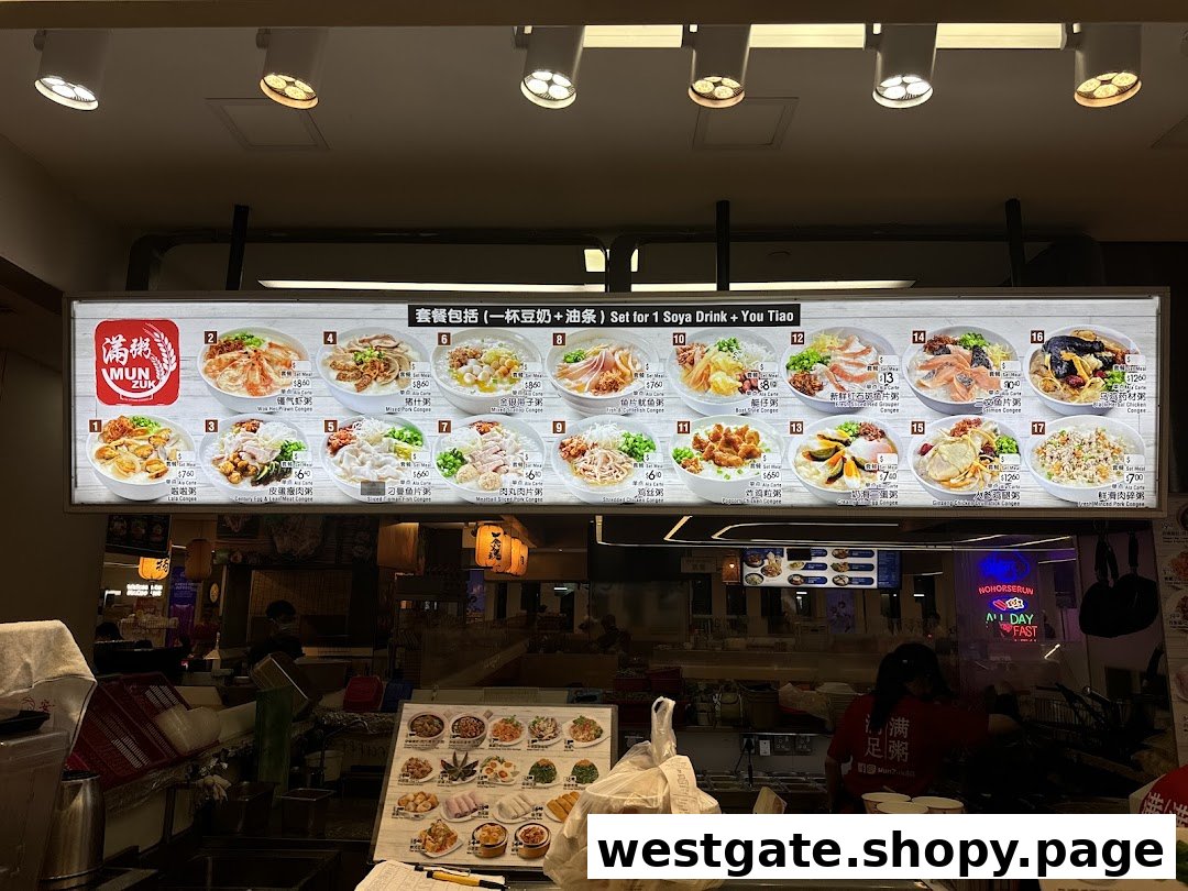 A brightly lit menu board displaying various congee dishes and their prices above a bustling shop counter.