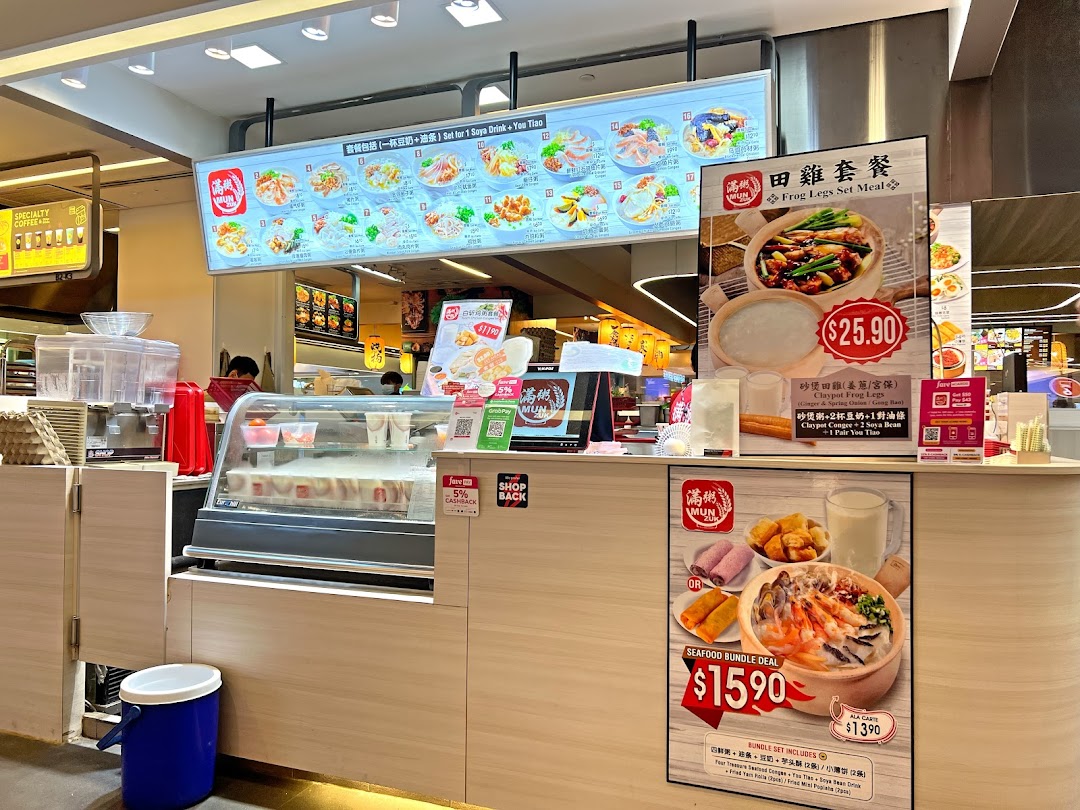 A bustling food stall counter at Mun Zuk Westgate, featuring digital menus and promotional offers.