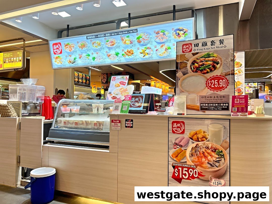 A bustling food stall counter at Mun Zuk Westgate, featuring digital menus and promotional offers.