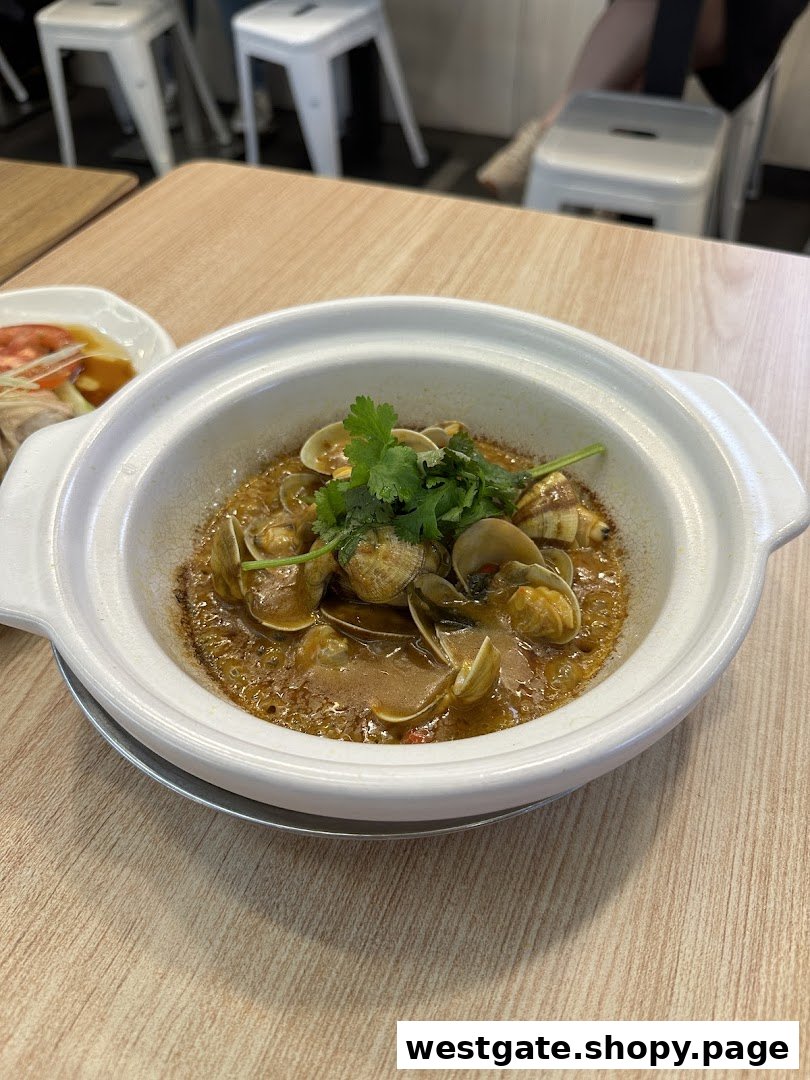 A ceramic pot filled with savory clams and broth, garnished with fresh cilantro, on a wooden table.