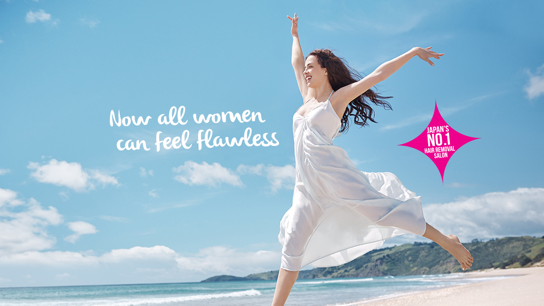 A woman joyfully leaping on a beach, promoting a hair removal salon's promise of flawlessness.