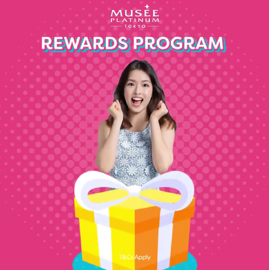 An excited woman with a gift box promoting Musee Platinum Tokyo's Rewards Program.