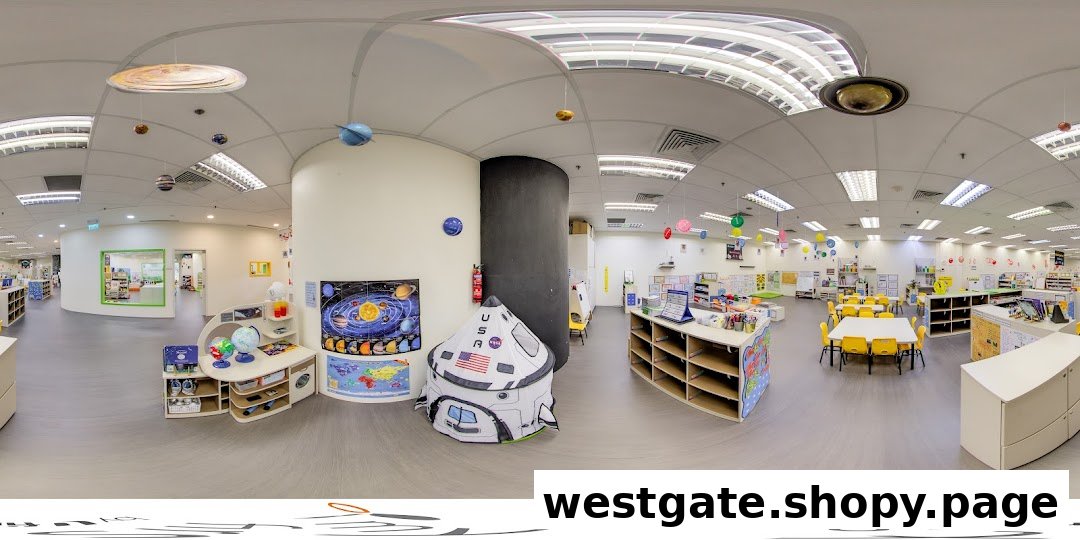 Bright, spacious interior of a childcare center with learning stations, play areas, and child-sized furniture.