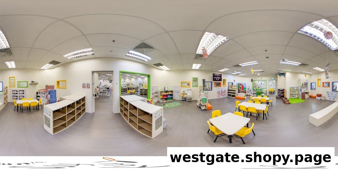 A bright, spacious interior of a childcare center with child-sized tables, chairs, and learning activity areas.