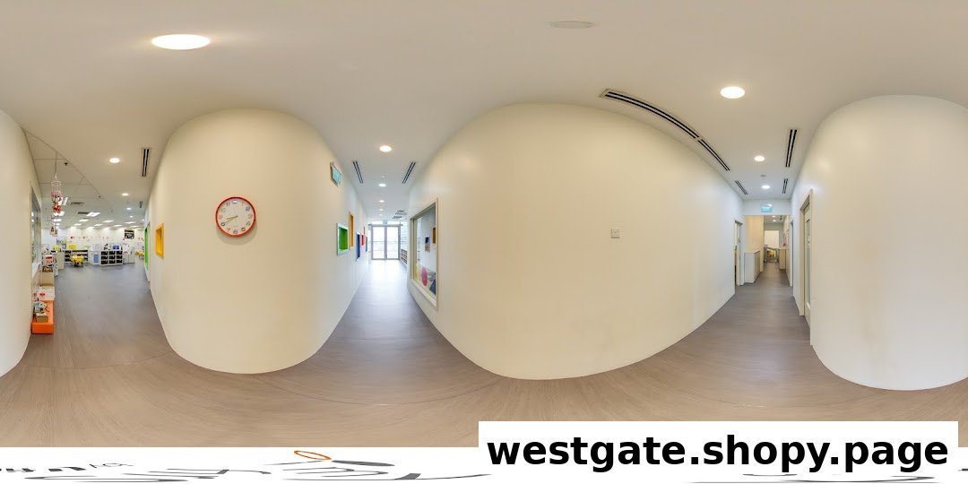 A bright, clean hallway inside My First Skool, featuring a clock and glimpses into learning spaces.