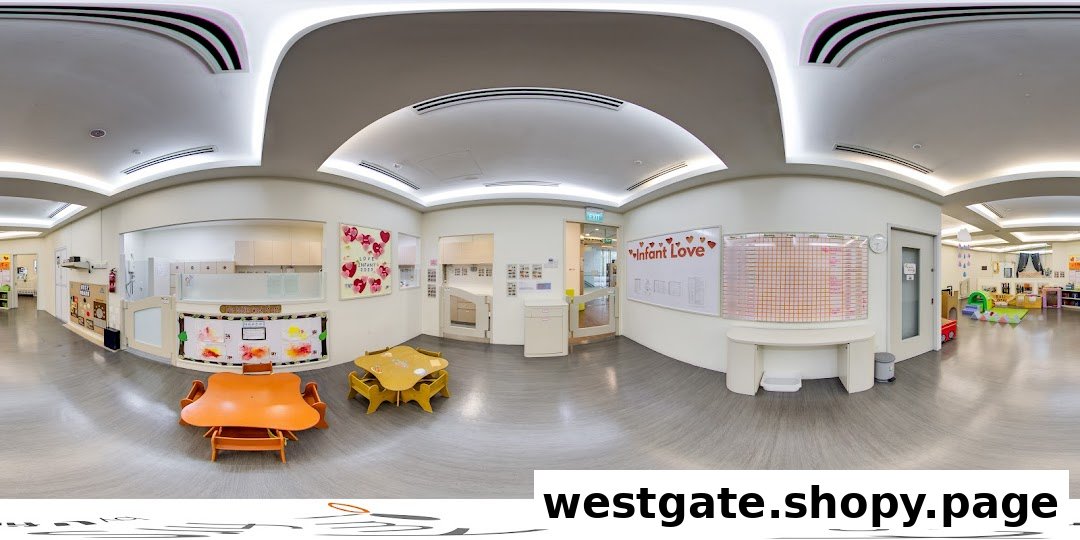 A bright, clean interior of a childcare center with small tables, chairs, and dedicated play areas.