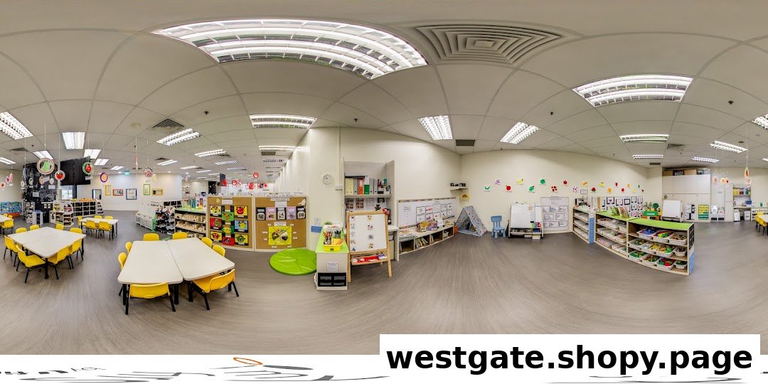 A wide-angle view of a bright, spacious classroom with colorful learning materials and child-sized furniture.