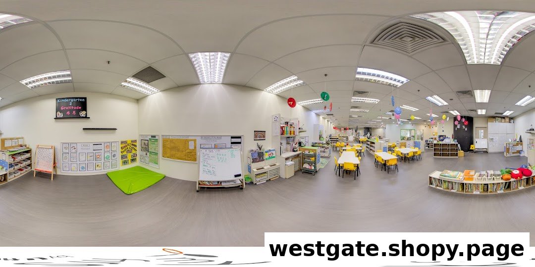 A bright, spacious kindergarten classroom with colorful learning areas, child-sized tables, and educational displays.
