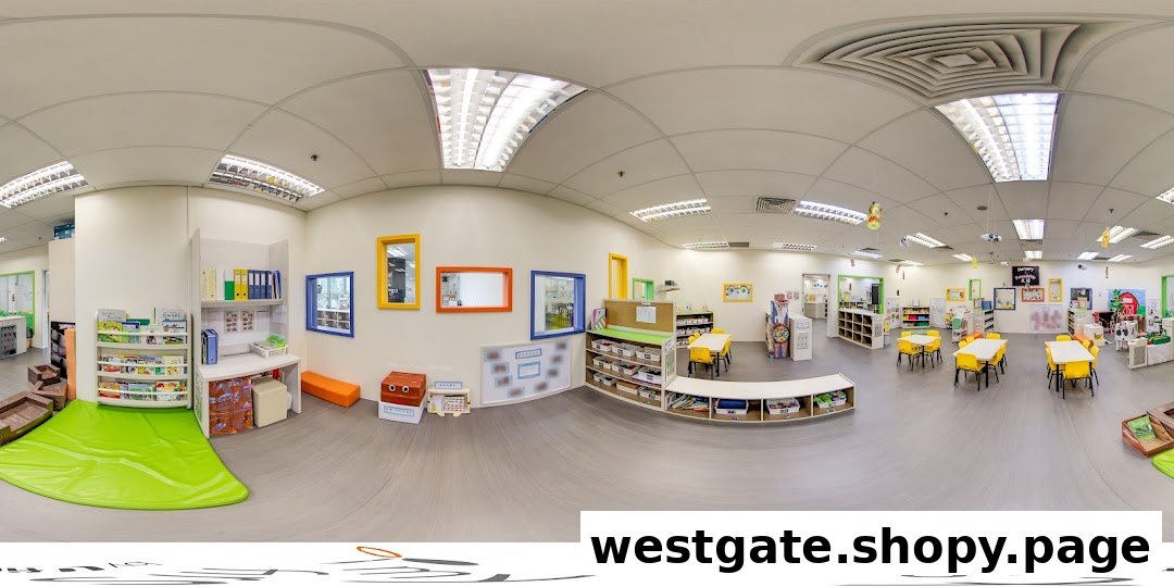 A bright and organized interior of a childcare center with play areas, tables, and learning materials.