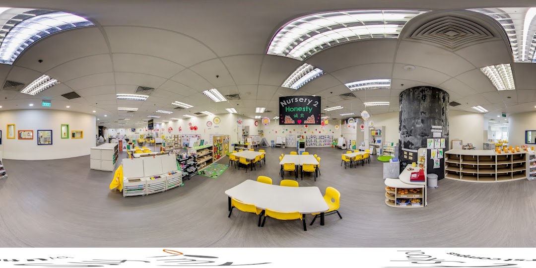 A bright, spacious classroom at My First Skool, featuring colorful tables, chairs, and learning activity areas.