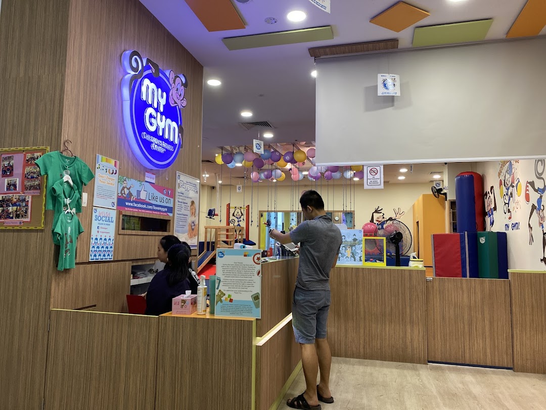 An interior view of My Gym Jurong East, showing the reception area and a colorful play space.
