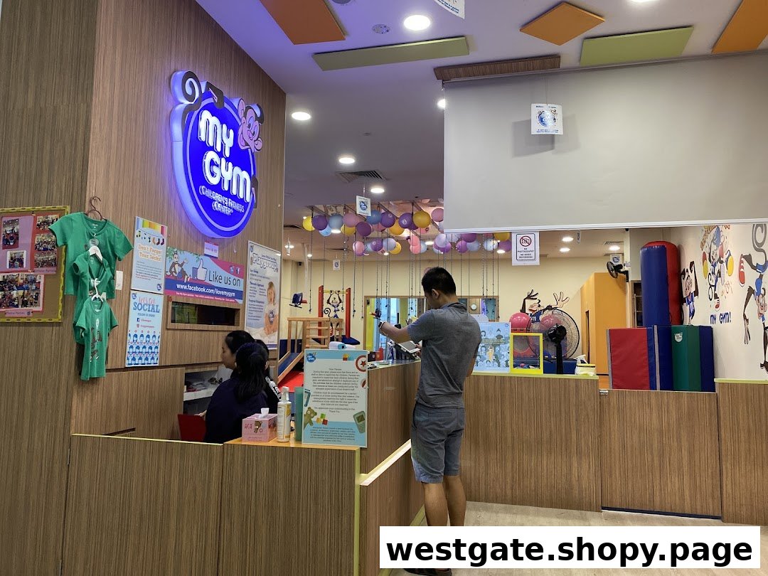 An interior view of My Gym Jurong East, showing the reception area and a colorful play space.