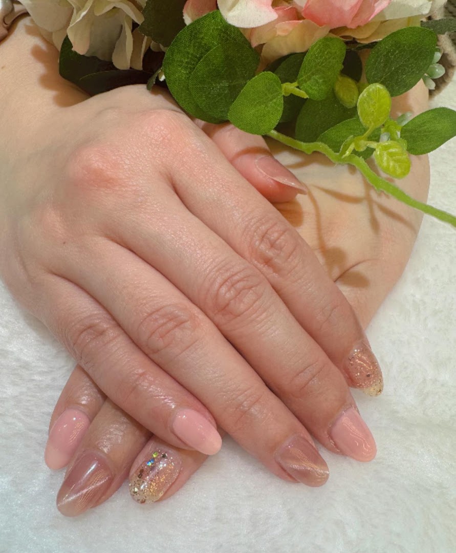 Close-up of hands showcasing a beautiful manicure with varied nail art designs.