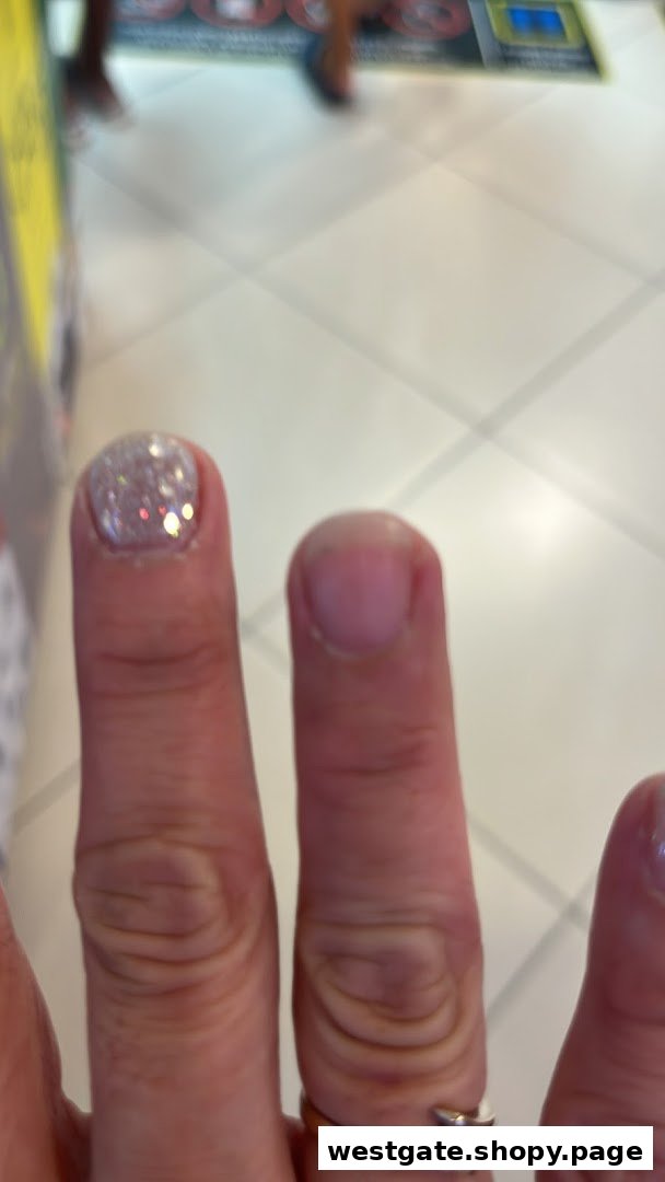 Close-up of a hand showcasing a freshly applied glitter nail polish from Nailz Gallery.
