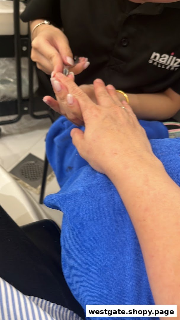 A customer receives a manicure service from a technician at Nailz Gallery.