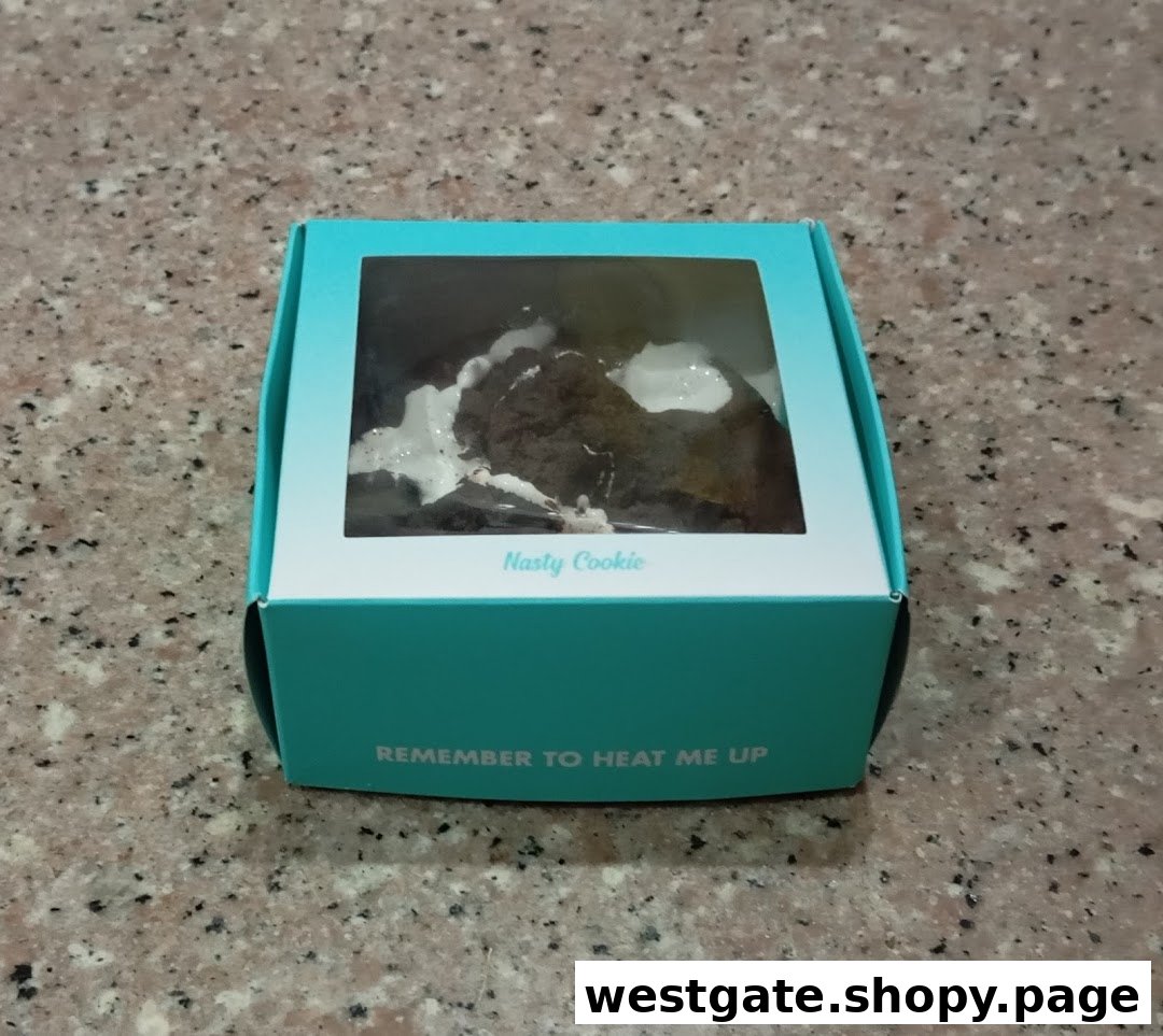 A Nasty Cookie in its signature teal box, with a visible cookie inside.
